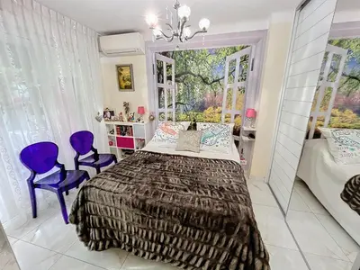 a bedroom with a large bed and purple chairs at Cosy 1 bedroom Republique 236 in Cannes