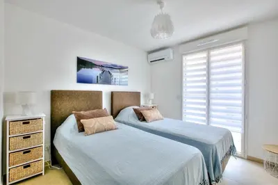 a bedroom with two beds and a window at superbe 3 chambres proche palais et croisette dag13 in Cannes