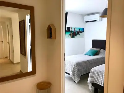 a room with a bed and a mirror and a bedroom at superbe 3 chambres proche palais et croisette dag13 in Cannes