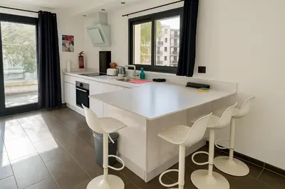 a living room with a couch and a table at AgarrusRentals 70m2, 2 chambres pour 4 Personnes avec bébé avec Terrasses a 200m des Plages, Palmbee Cannes in Cannes