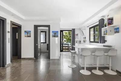 a kitchen with a counter and two stools at AgarrusRentals 70m2, 2 chambres pour 4 Personnes avec bébé avec Terrasses a 200m des Plages, Palmbee Cannes in Cannes