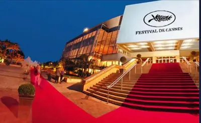 a woman walking down a red carpet in front of a building at Jo Malone in Cannes