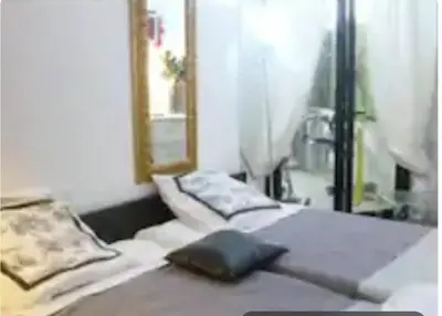 a room with a bed with a black object on it at Jo Malone in Cannes