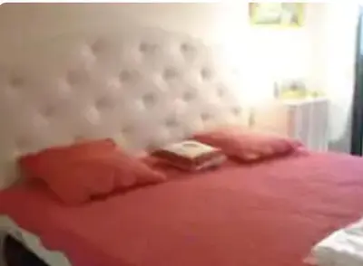 a bedroom with a pink bed with a white headboard at Jo Malone in Cannes