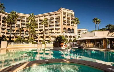 a swimming pool in front of a large building at Le Cannes Beach 799 - terrasse vue mer panoramique in Cannes