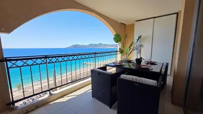 a room with a balcony with a view of the ocean at Le Cannes Beach 799 - terrasse vue mer panoramique in Cannes