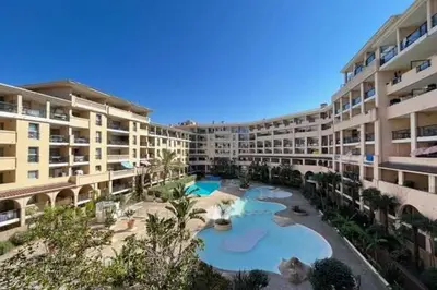 an apartment building with a large swimming pool at Le Cannes Beach 799 - terrasse vue mer panoramique in Cannes