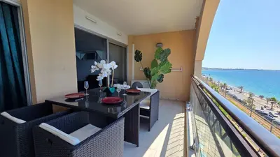 a balcony with a table and a view of the ocean at Le Cannes Beach 799 - terrasse vue mer panoramique in Cannes
