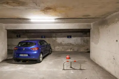 a blue car parked in a parking garage at RIO - 200 m plages - App 6pers- climatisé, terrasse, piscine, parking in Cannes