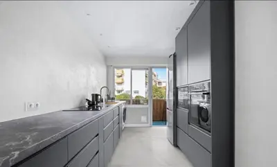 a kitchen with a sink and a microwave at Le Royal in Cannes