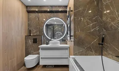 a bathroom with a toilet and a sink and a mirror at Le Royal in Cannes