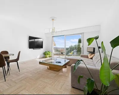 a living room with a couch and a table at Le Royal in Cannes