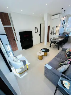 a living room with a couch and chairs and a table at 3 pièces en cœur de cannes in Cannes