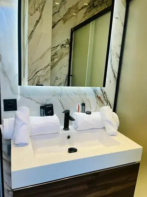 a bathroom with a white sink and a mirror at 3 pièces en cœur de cannes in Cannes