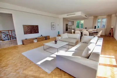 a living room with a couch and a table at Luxury Cannes Film Festival Townhouse 3 Bedrooms Private Pool & Terrace in Cannes