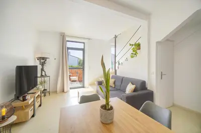a living room with a table and a couch at Charmant duplex proche de Cannes centre et à 2min à pied de la mer in Cannes
