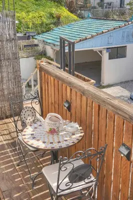 a table and chairs on a balcony with a coffee cup at Charmant duplex proche de Cannes centre et à 2min à pied de la mer in Cannes