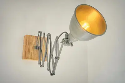 a light hanging on a wall with some utensils at Charmant duplex proche de Cannes centre et à 2min à pied de la mer in Cannes