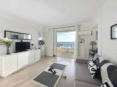 a white living room with a view of the ocean at Stunning sea view on La Croisette in Cannes