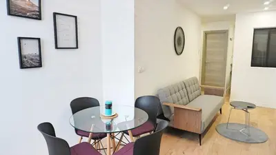 a dining room with a glass table and chairs at Proche Carlton & Croisette, Appartement 202 - Palmazur Vacances in Cannes