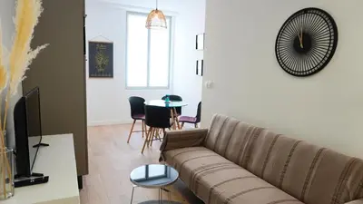 a living room with a couch and a table at Proche Carlton & Croisette, Appartement 202 - Palmazur Vacances in Cannes