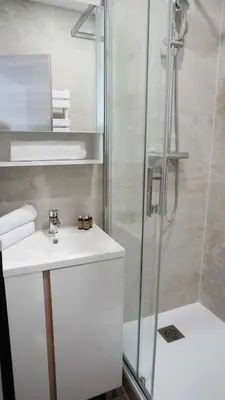 a bathroom with a white sink and a shower at Proche Carlton & Croisette, Appartement 202 - Palmazur Vacances in Cannes