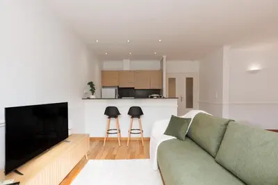 a living room with a couch and a kitchen at L'Azuréa - Centre - Plage - Wifi - Climatisation in Cannes