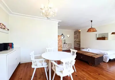 a dining room with a table and chairs and a bed at Viva Riviera 5 Rue Florian in Cannes