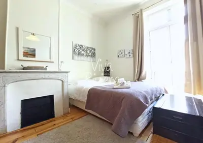 a bedroom with a bed and a fireplace at Viva Riviera 5 Rue Florian in Cannes