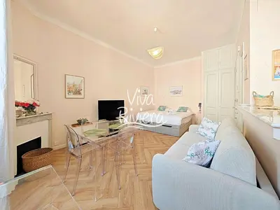 a living room with a couch and a table at Viva Riviera 5 Rue Florian in Cannes
