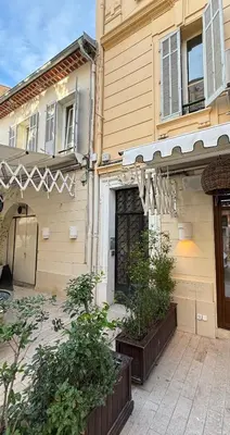 a house with an awning and plants in front of it at Viva Riviera 5 Rue Florian in Cannes