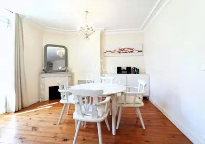 a white dining room with a white table and chairs at Viva Riviera 5 Rue Florian in Cannes