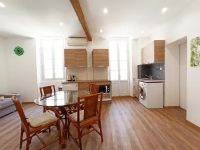 a kitchen and dining room with a table and chairs at Viva Riviera 6 Rue Commandant André in Cannes