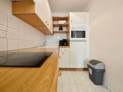 a kitchen with white appliances and a trash can at Viva Riviera 6 Rue Commandant André in Cannes
