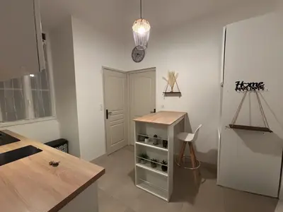 a kitchen with a white refrigerator and a table at Cosy Apartment in Cannes, AC, WiFi, 15min Palais in Cannes