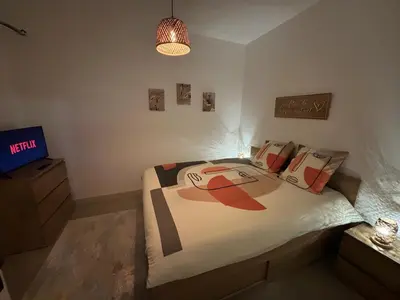 a bedroom with a bed and a tv in it at Cosy Apartment in Cannes, AC, WiFi, 15min Palais in Cannes