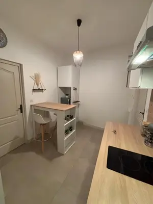 a kitchen with a desk and a table in a room at Cosy Apartment in Cannes, AC, WiFi, 15min Palais in Cannes