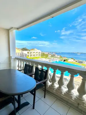 a balcony with a table and a view of the ocean at Sisley 1061 - F2 Terrasse avec vue mer in Cannes