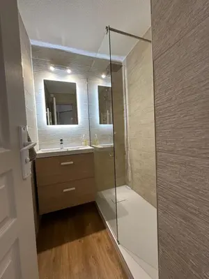 a bathroom with a shower and a sink and a mirror at Sisley 1061 - F2 Terrasse avec vue mer in Cannes