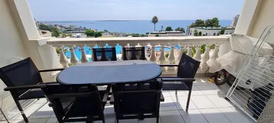 a table and chairs on a balcony with a view of the ocean at Sisley 1061 - F2 Terrasse avec vue mer in Cannes