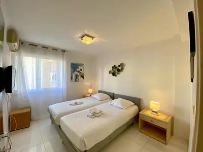 a white bedroom with a bed and a window at Spacieux 3 chambres BALCON, MARTINEZ -CARLTON A3B130 in Cannes