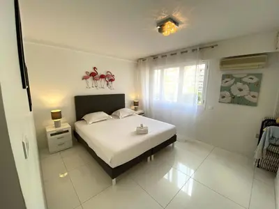 a white bedroom with a bed with two figurines on it at Spacieux 3 chambres BALCON, MARTINEZ -CARLTON A3B130 in Cannes