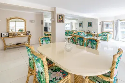 a dining room with a white table and chairs at Spacieux 3 chambres BALCON, MARTINEZ -CARLTON A3B130 in Cannes