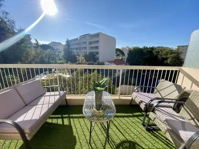 a balcony with a couch and a table and chairs at Cannes proche Croisette - 2P tout confort terrasse in Cannes
