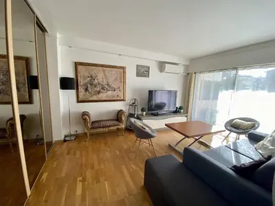 a living room with a couch and a table at Cannes proche Croisette - 2P tout confort terrasse in Cannes
