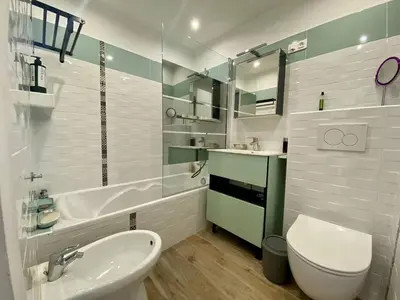 a bathroom with a sink and a toilet and a tub at Cannes proche Croisette - 2P tout confort terrasse in Cannes