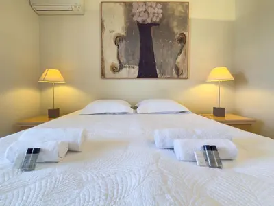 a bedroom with a white bed with towels on it at The Artist by Winsome Destination in Cannes