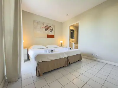 a hotel room with a large bed and a bathroom at The Artist by Winsome Destination in Cannes