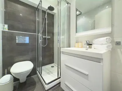 a bathroom with a shower and a toilet and a sink at The Artist by Winsome Destination in Cannes