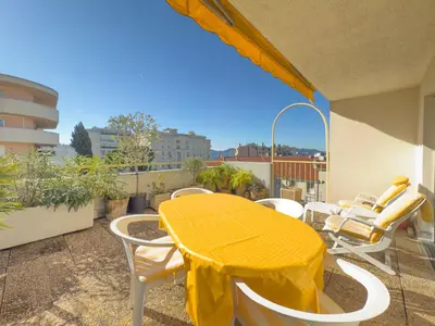 a yellow table and chairs on a balcony at The Artist by Winsome Destination in Cannes
